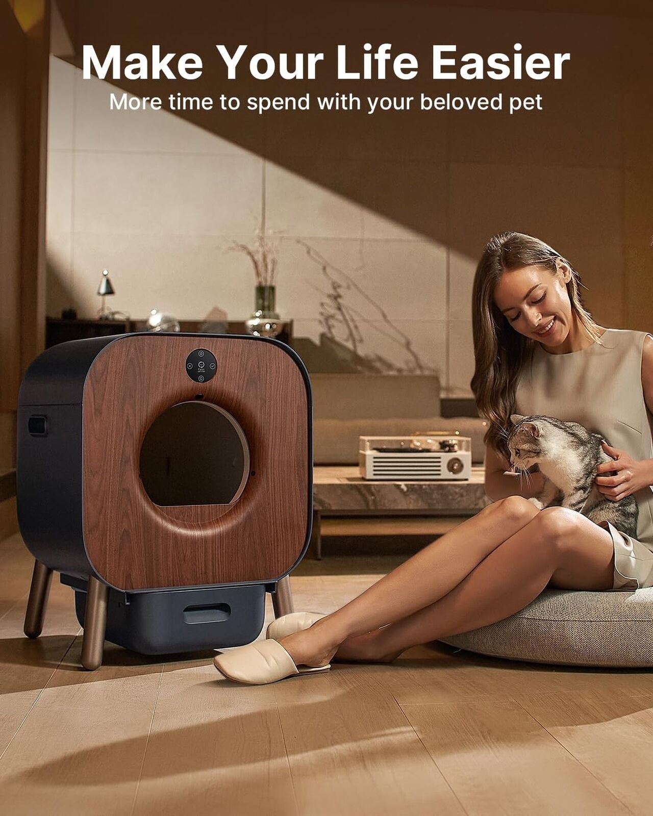 Automatic self-cleaning litter box for multiple cats in modern living room setting.